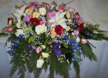 Rainbow of Colors Casket Spray from Clark Flower and Gift Shop in Clark, SD