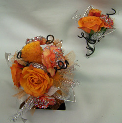 Orange Spray Roses & MiniCarnations Wrist Corsage from Clark Flower and Gift Shop in Clark, SD